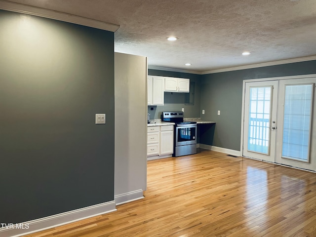 kitchen with electric range, crown molding, light wood-style flooring, light countertops, and white cabinets