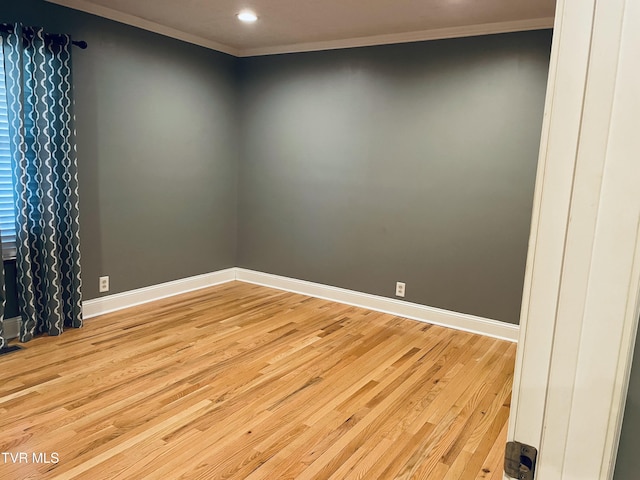 unfurnished room with light wood finished floors, ornamental molding, baseboards, and recessed lighting
