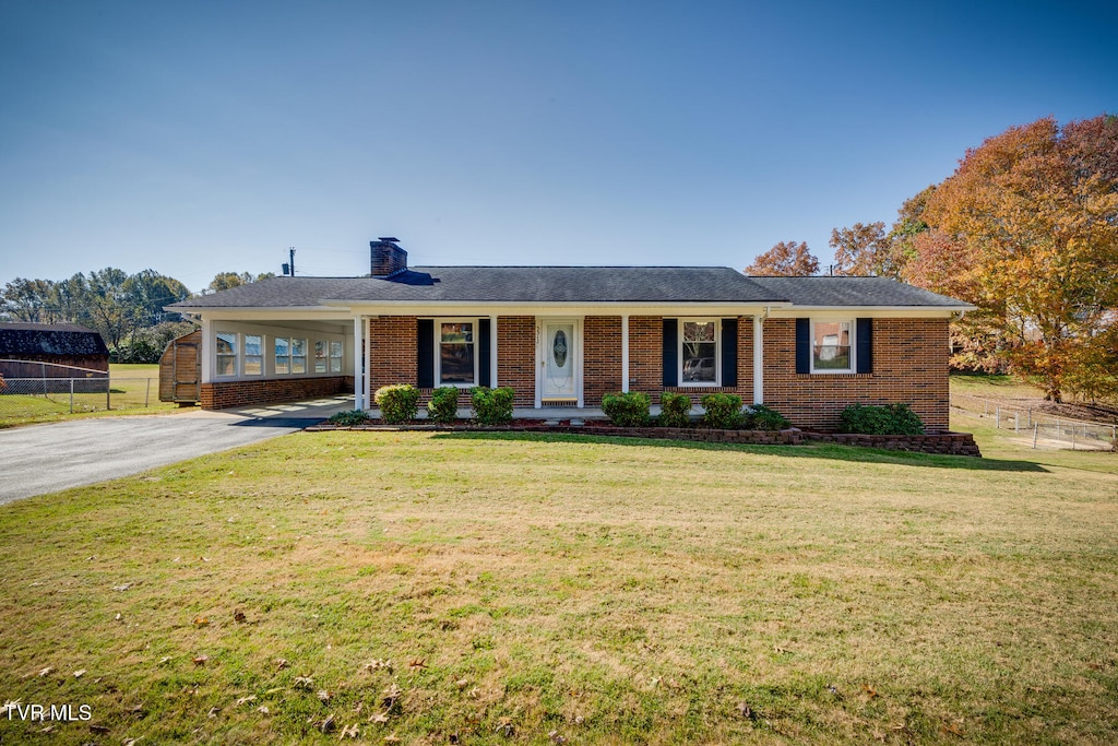 ranch-style house with a front lawn and covered porch