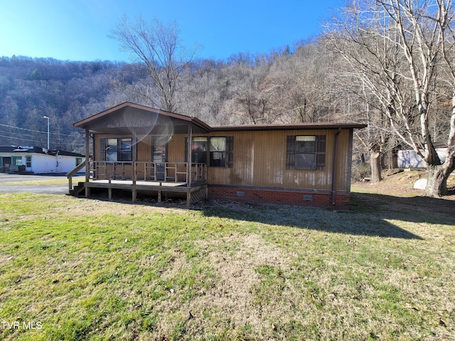 view of front of property with covered porch and a front lawn