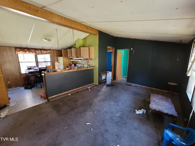 kitchen featuring dark wood-type flooring, wooden walls, and vaulted ceiling with beams