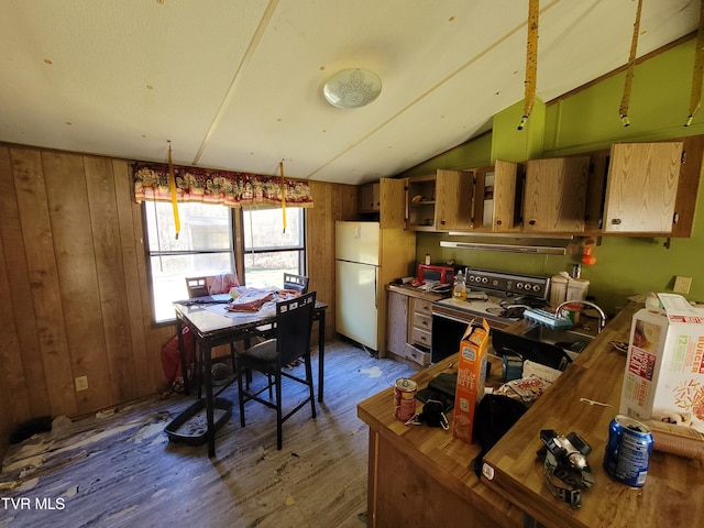 kitchen with dark hardwood / wood-style floors, extractor fan, vaulted ceiling, white refrigerator, and electric stove