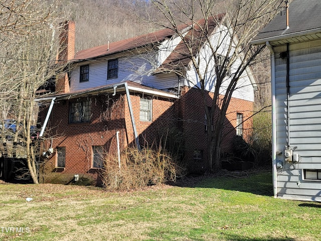 view of home's exterior with a yard