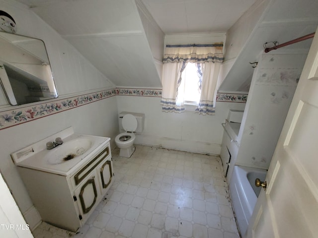 bathroom with lofted ceiling, vanity, a tub, and toilet