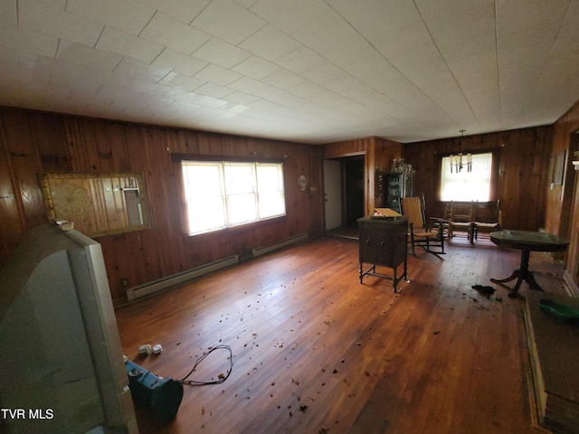 interior space with wood walls, dark wood-type flooring, and a wealth of natural light