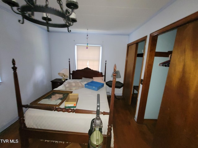 bedroom with dark hardwood / wood-style floors