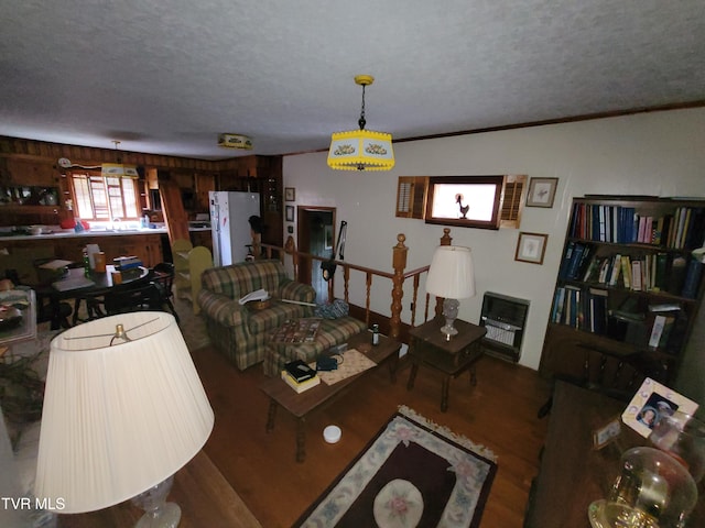 living room with a wealth of natural light, a textured ceiling, and hardwood / wood-style flooring