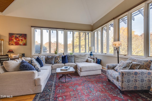 sunroom / solarium featuring vaulted ceiling