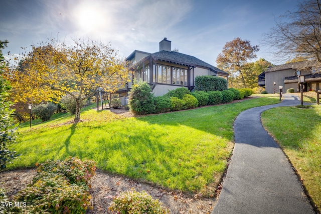 view of side of property with a yard