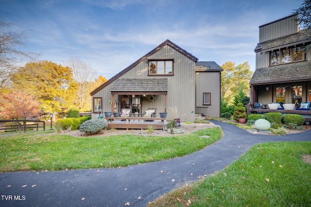 back of house featuring a yard and a deck