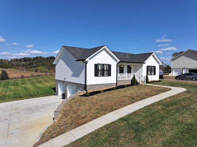 view of front of property with a front yard, covered porch, and a garage