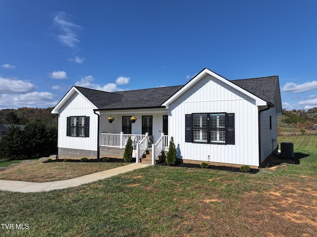 modern inspired farmhouse featuring a porch, a front lawn, and central air condition unit