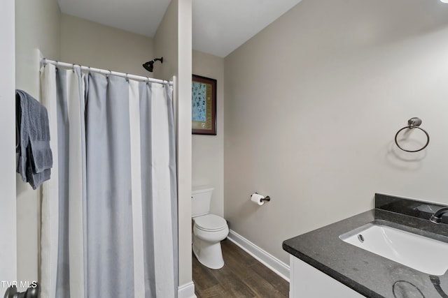 bathroom with vanity, a shower with curtain, hardwood / wood-style flooring, and toilet