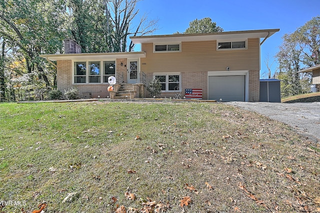 split level home featuring a front lawn and a garage