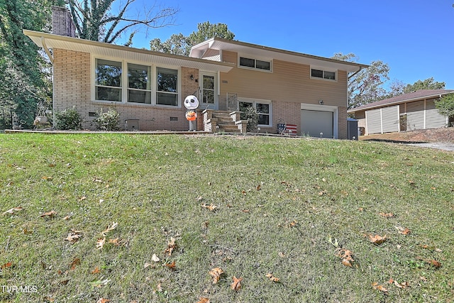 split level home featuring a front yard and a garage