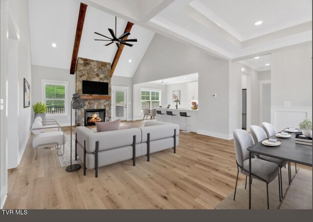 633 Uncle Buddys Way, Jonesborough, TN 37659 - living room featuring high vaulted ceiling, light wood-type flooring, a ceiling fan, a fireplace, and beam ceiling