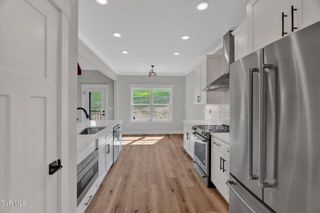 633 Uncle Buddys Way, Jonesborough, TN 37659 - kitchen with appliances with stainless steel finishes, a sink, wall chimney exhaust hood, recessed lighting, and light wood finished floors