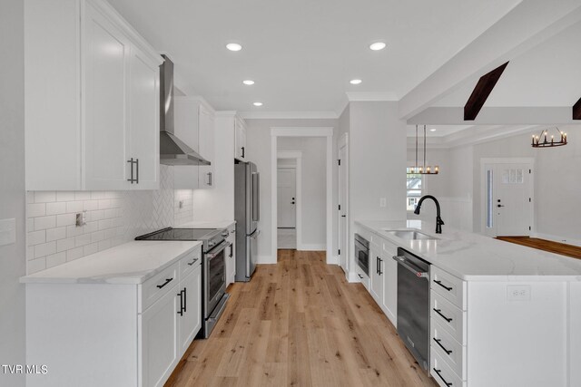 633 Uncle Buddys Way, Jonesborough, TN 37659 - kitchen featuring appliances with stainless steel finishes, a sink, wall chimney range hood, a chandelier, and a peninsula