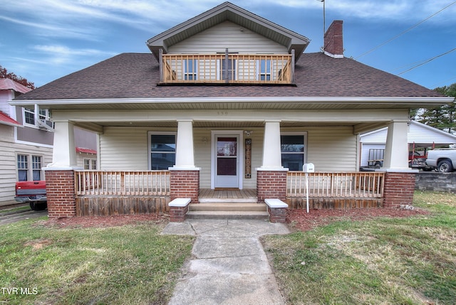 view of front of home with a front yard and a porch