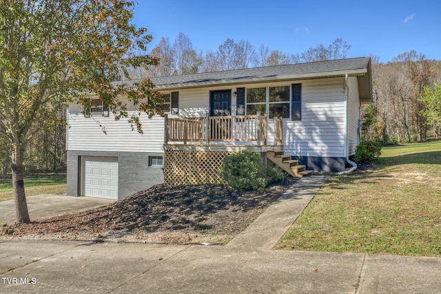 single story home with a front yard, a wooden deck, and a garage