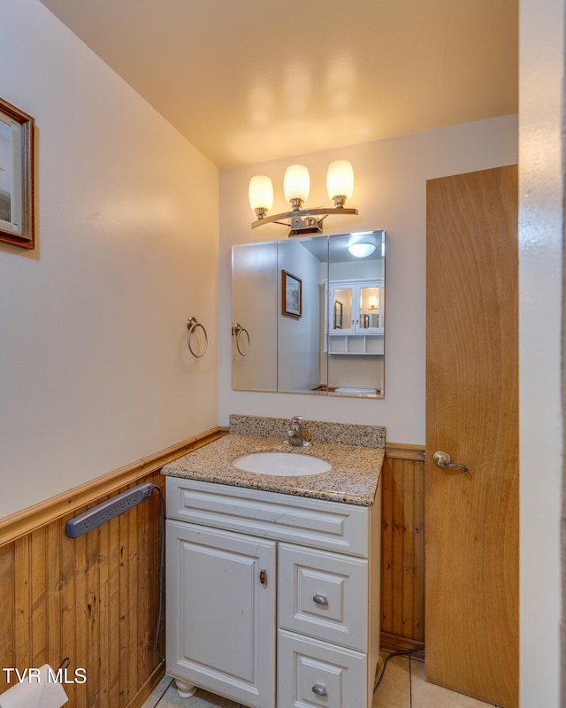 bathroom with vanity and wooden walls