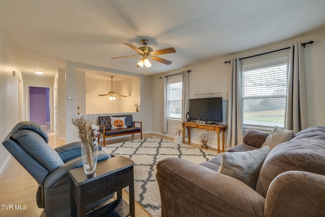 living room featuring light wood-type flooring and ceiling fan