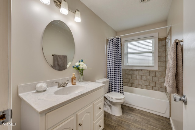 full bathroom with vanity, hardwood / wood-style floors, shower / bath combo with shower curtain, and toilet