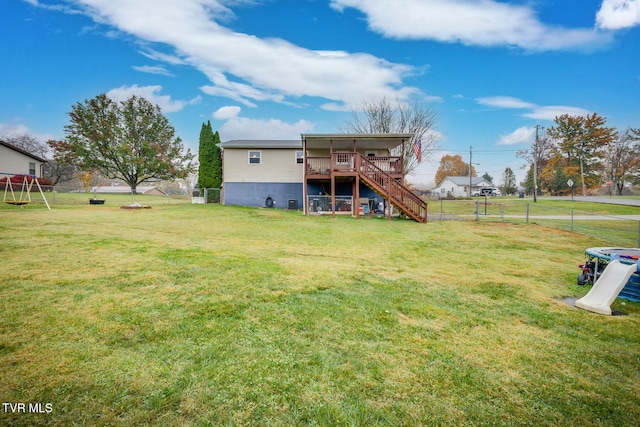 rear view of property with a deck and a yard