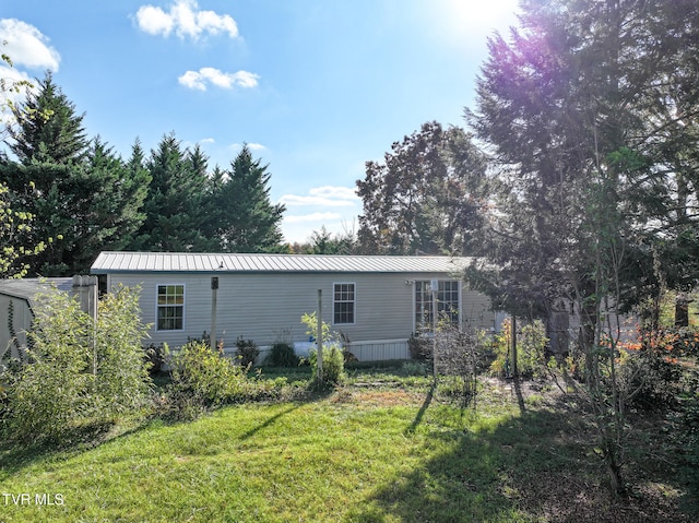 rear view of property with a lawn