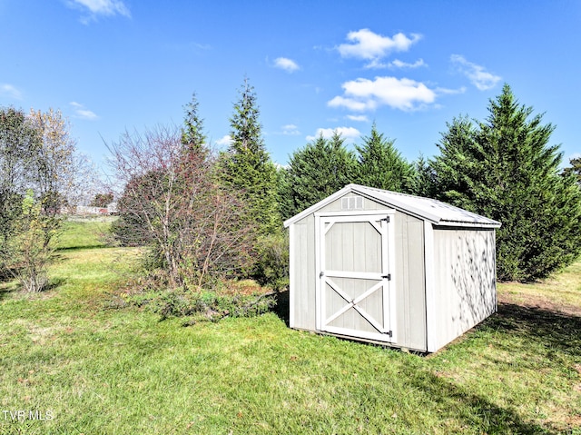 view of outdoor structure featuring a lawn