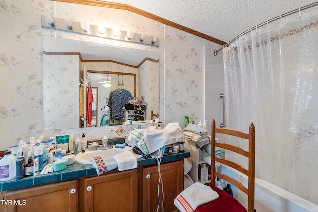 bathroom featuring shower / tub combo, a textured ceiling, ceiling fan, vanity, and ornamental molding