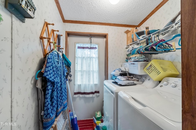 laundry room featuring ornamental molding, a textured ceiling, and washing machine and clothes dryer