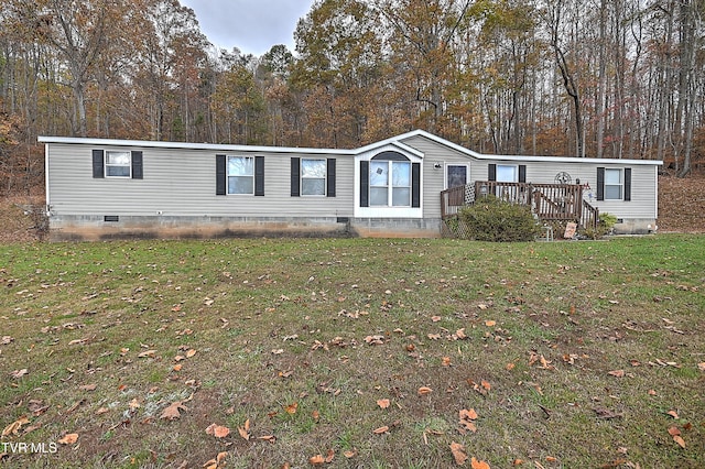 manufactured / mobile home with a front yard and a deck