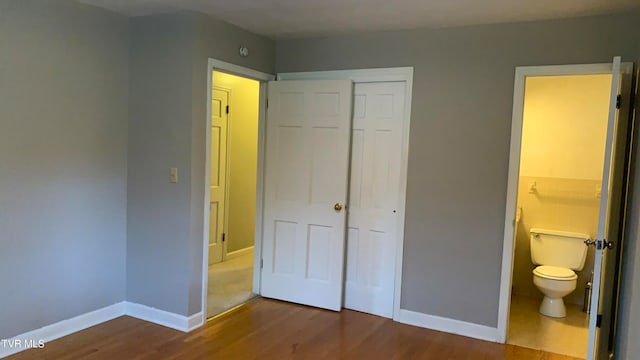 unfurnished bedroom featuring hardwood / wood-style flooring and a closet