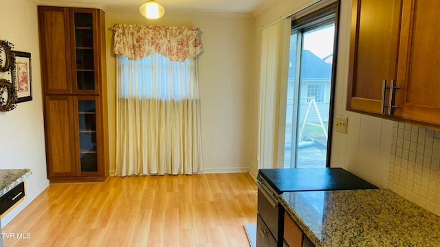 dining space with light hardwood / wood-style flooring and crown molding