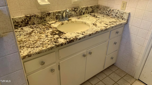 bathroom featuring vanity, tile patterned floors, and tile walls