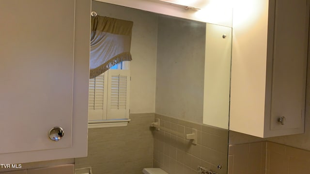 bathroom with tile walls