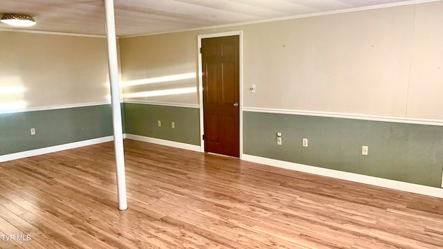 unfurnished room with hardwood / wood-style flooring and ornamental molding