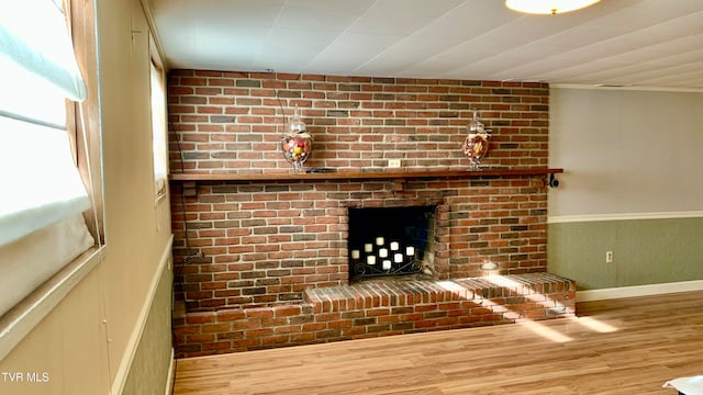 unfurnished living room featuring light hardwood / wood-style floors and a fireplace