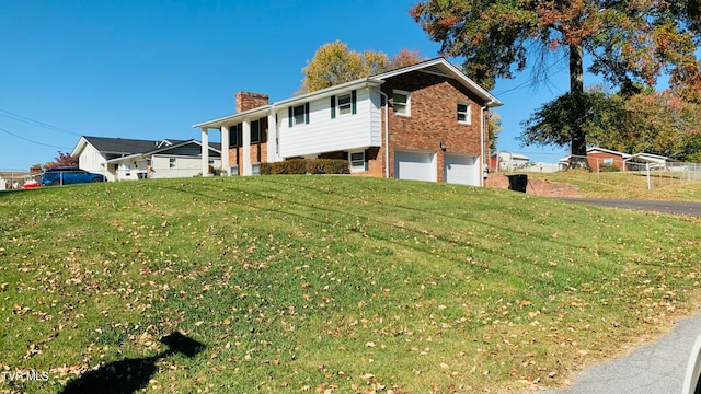 view of front of property with a garage and a front yard