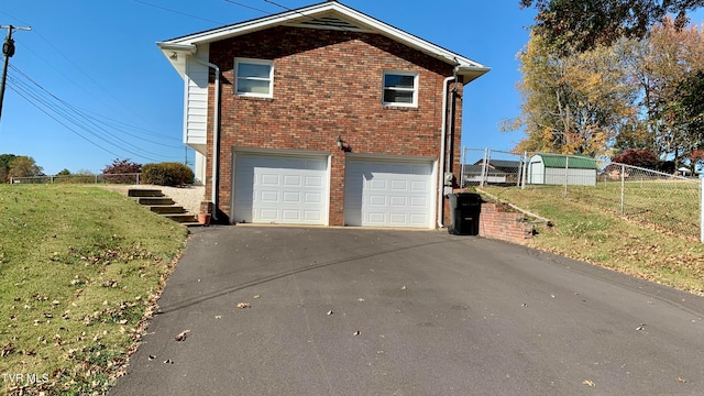 view of side of property with a garage and a yard