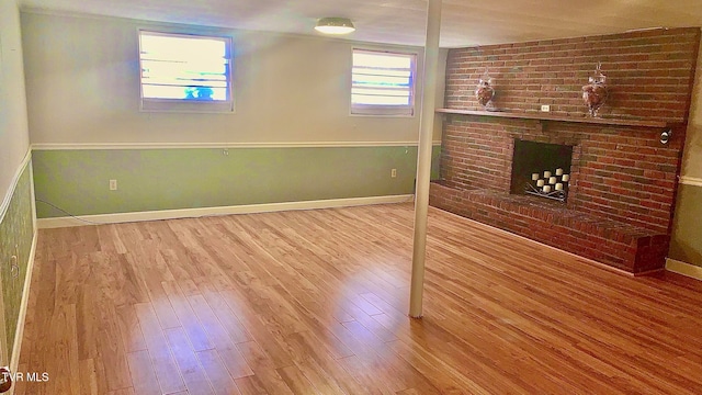 basement featuring a fireplace and hardwood / wood-style flooring