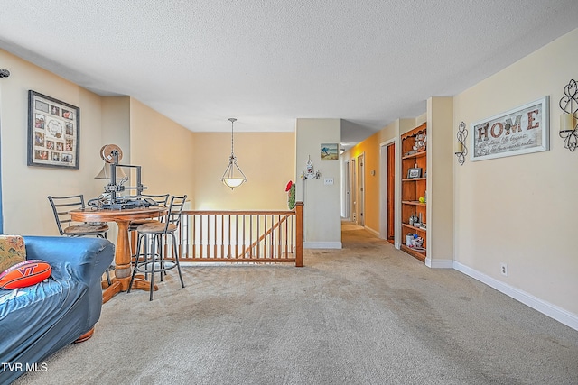 interior space featuring light carpet and a textured ceiling