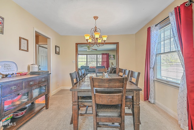 dining space featuring a notable chandelier and light colored carpet