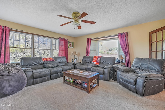 carpeted living room with a textured ceiling, a healthy amount of sunlight, and ceiling fan