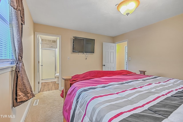 carpeted bedroom with ensuite bathroom