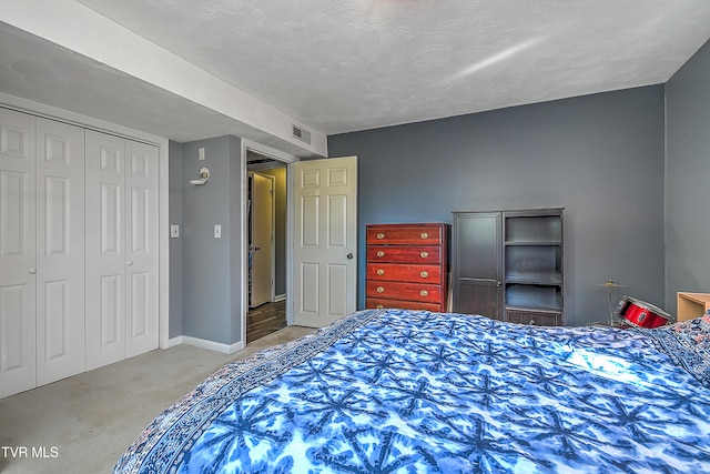 bedroom with a textured ceiling and a closet