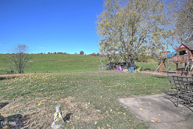 view of yard with a playground and a rural view