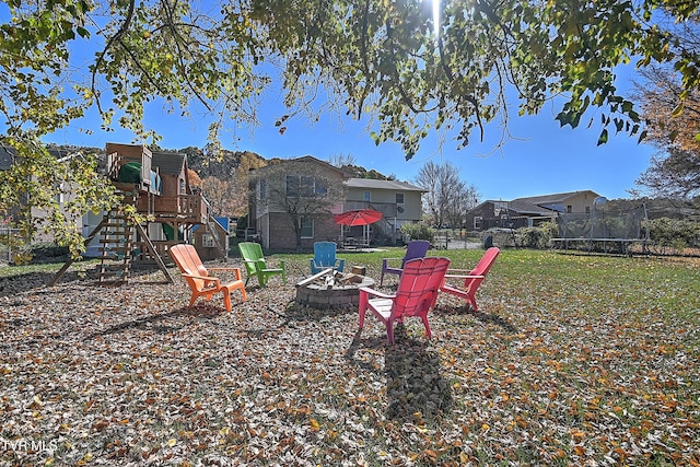 view of yard with a playground and a fire pit