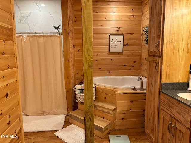 bathroom with vanity, wood-type flooring, and independent shower and bath